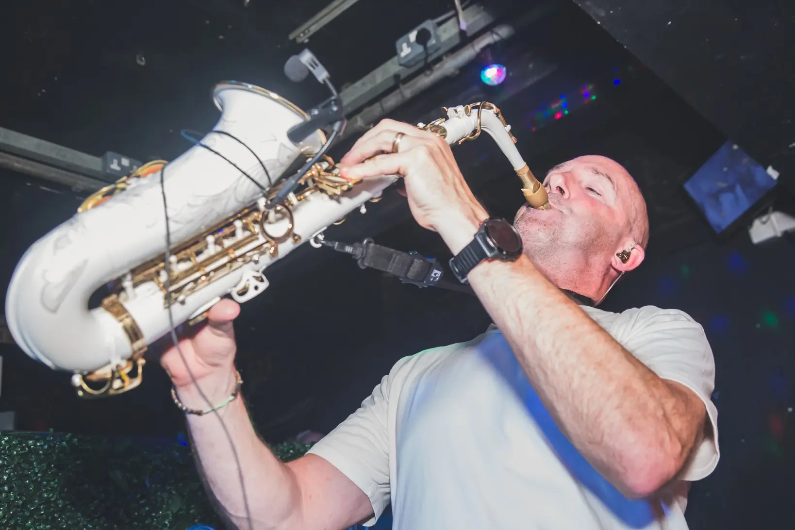 A saxophone player performing live music in the nightclub